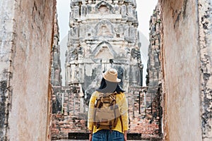 Asian tourist woman take a photo of ancient of pagoda temple thai architecture at Sukhothai,Thailand. Female traveler in casual t