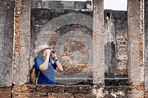 Asian tourist woman take a photo of ancient of temple thai architecture at Sukhothai,Thailand. Female traveler in casual thai