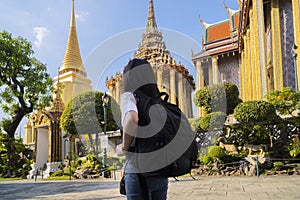 Asian tourist women travel in old Thai buddhist temple outdoor, in Wat phra kaew and grand palace travel in Bangkok city