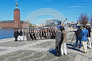 Asian tourists make group photo with the City Hall (Stadshuset) at the background in Stockholm, Sweden.