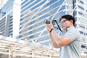 Asian tourists are standing, taking pictures with a tourist camera in the city