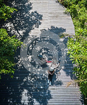 Asian traveler holiday relax with bicycle in nature park