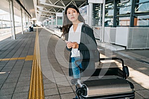 Asian traveler using smart phone contacting