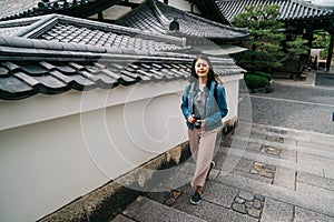 An asian traveler walking up the stairs