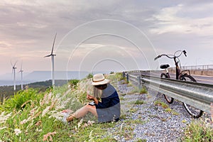 Asian traveler woman in jean dress relaxing holiday with classic bicycle