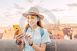 Asian traveler woman smiling and using a smartphone in Nuremberg old town