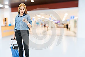 Asian Traveler women looking for flight in smartphone at airport terminal Travel concept