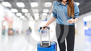 Asian Traveler women looking for flight in smartphone at airport terminal Travel concept