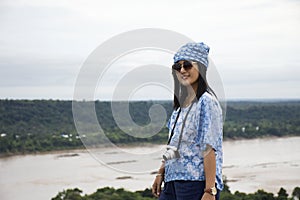 Asian travelers thai women travel and posing at viewpoint cliffs