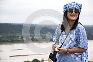 Asian travelers thai women travel and posing at viewpoint cliffs