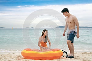 Asian traveller couple playing and sweet togather on the beach between honeymoon day at Phi phi island maya beach