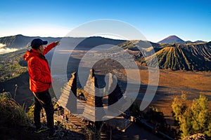 Asian traveller stand at top of Seruni view point for see sunrise at Bromo mountain