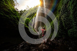 Asian traveller take photo in Madakaripura Water fall