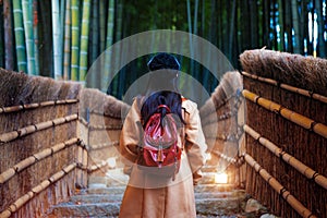 Asian traveller walk in bamboo forest in arashiyama