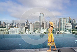 Asian traveller woman sleep and relax at swimming pool