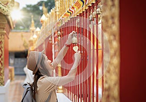 Asian traveller woman travel in Wat phrathat doi suthep with buddha statue in Chiang mai