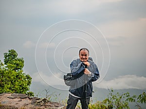 Asian Trekker with secnery view in the morning on Phu Kradueng mountain national park in Loei City Thailand