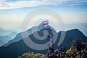 Asian trekking man holding Thailand flag