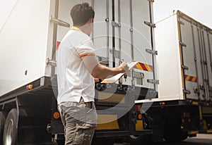 Asian A Truck Driver Holding Clipboard Inspecting Shipping Container Door. Truck inspection Safety Maintenance.