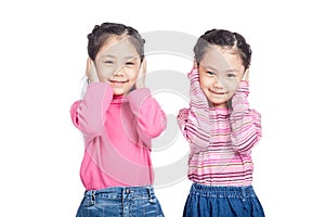 Asian twin sisters close their ears