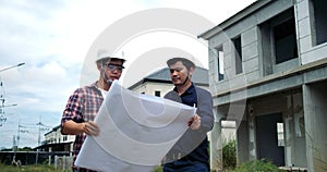 Asian two engineers are planning the construction