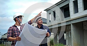 Asian two engineers are planning the construction