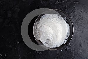 Asian uncooked vermicelli. Several bundles or rolls of dried starch mung beans,potatoes, rice, glass or cellophane noodles.