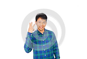 An Asian untidy man in blue plaid shirt is showing number one symbol by his fingers