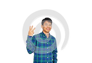 An Asian untidy man in blue plaid shirt is showing number three symbol by his fingers