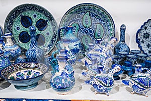 Asian Uzbek ceramic plates, jugs and dishes hand-painted in oriental market in Uzbekistan