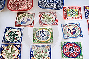 asian Uzbek handmade ceramic tiles with hand-painted traditional colorful patterns in pottery workshop in Uzbekistan