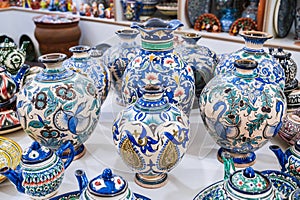 asian Uzbek handmade ceramic vases with hand-painted traditional patterns in pottery workshop in Uzbekistan