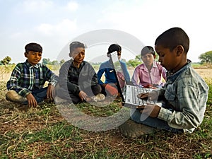 Asian village kids operating laptop at natural background in india January 2020