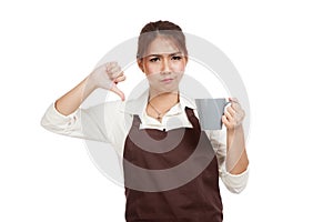 Asian waitress in apron thumbs down with cup of coffee