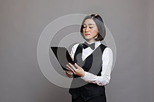 Asian waitress using digital tablet