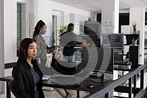 Asian web developer working with hologram and coding language