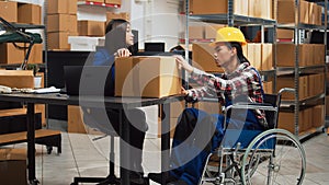 Asian wheelchair user working in warehouse space