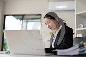 Asian woman accounting sit at their desks and calculate financial graph showing results about their investment, planning