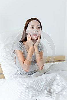 Asian woman adjust the facial mask