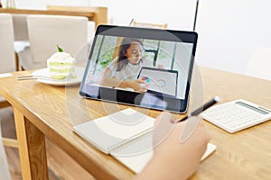 Asian woman aged 30-35 years using tablet, watching lesson online course communicate by conference video call from home, e-