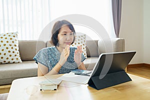 Asian woman aged 30-35 years using tablet, watching lesson Sign language online course communicate by conference video call from