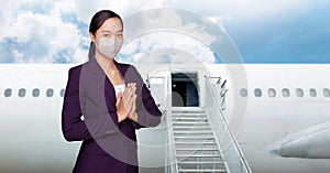 Asian woman air hostess in red uniform with white mask ation