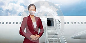 Asian woman air hostess in red uniform with white mask ation photo