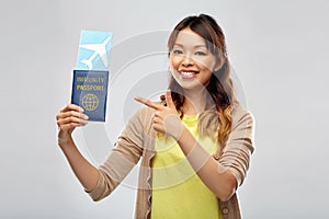 asian woman with air ticket and immunity passport