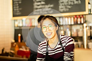 Asian woman amiling work in small business owner food and drink cafe.