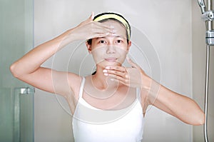 Woman applying aloe vera cream to face