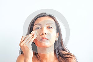 Asian woman applying foundation powder on face, skin problem. Beauty and Health
