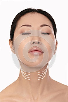 Asian woman with arrows on her face. neck lifting concept.