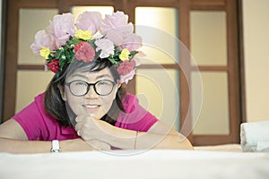 Asian woman with artificial flower bouguet decorated on head too