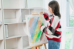 Asian Woman Artist Work and painting in the art studio at home